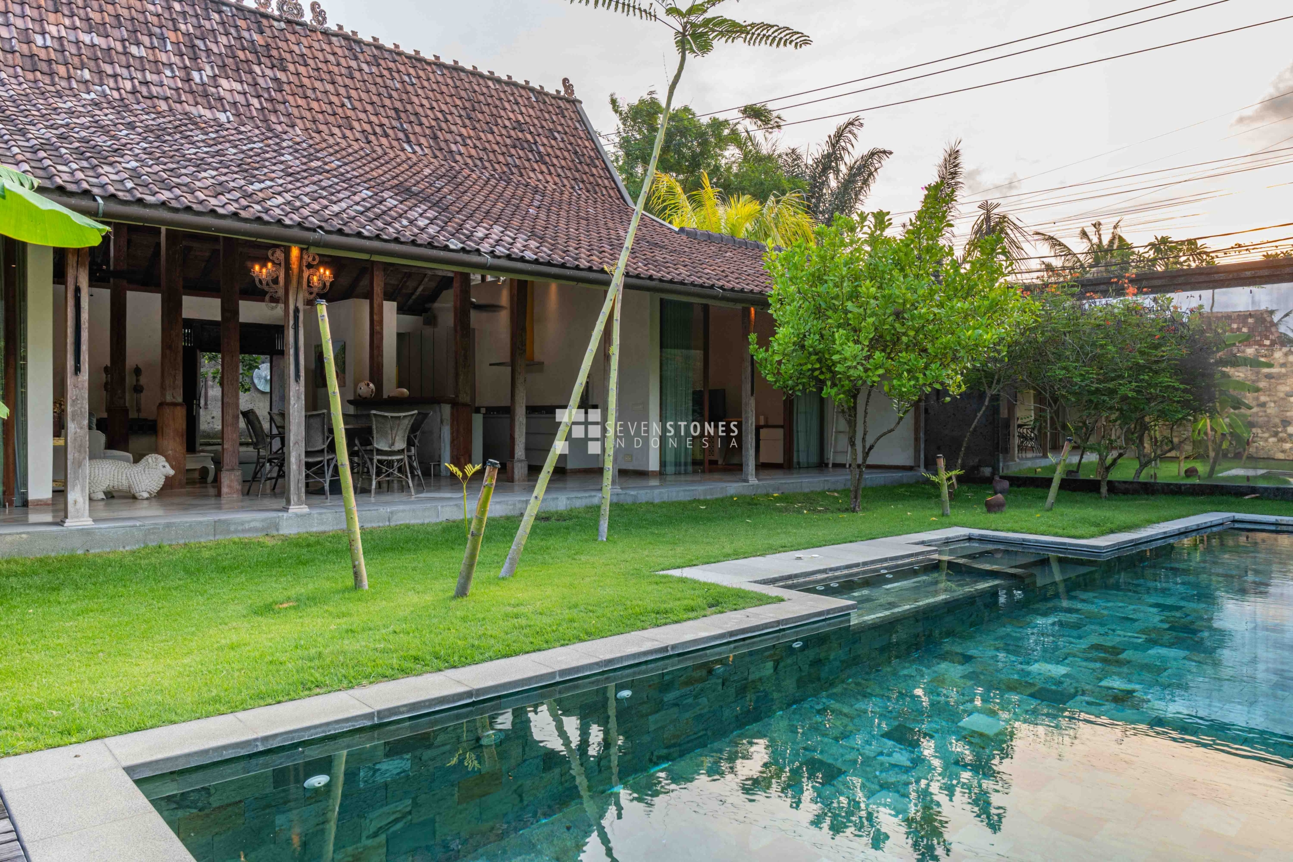 Stunning villa in Bali with a private pool surrounded by lush greenery, perfect for luxury villa investment in Bali.