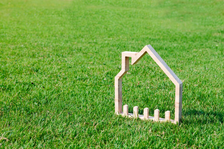 House icon in green field