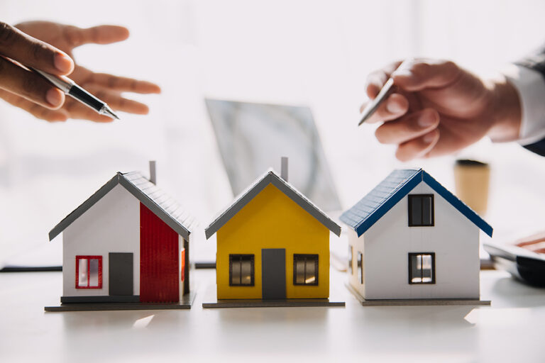 Real Estate Agent And Customer Signing Contract To Buy House