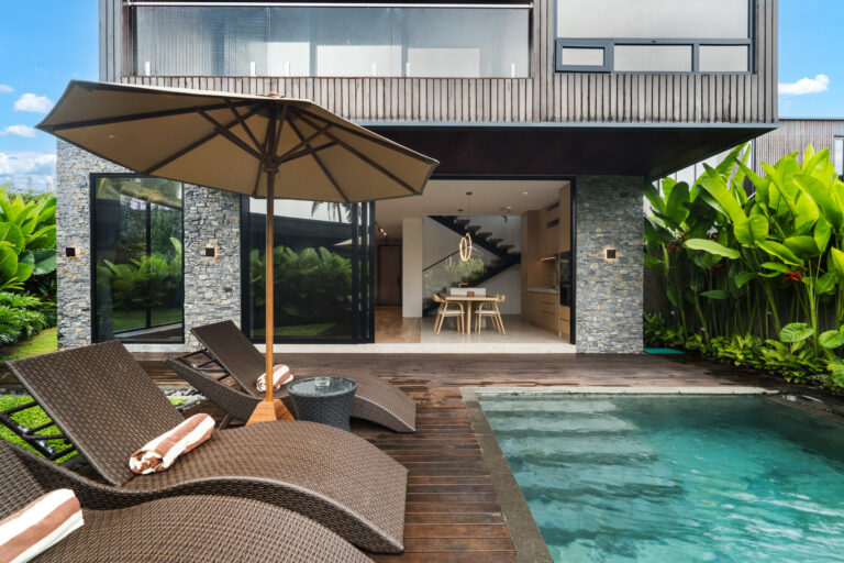Modern tropical villa with pool and sun loungers, perfect for Bali villas for rent long term.