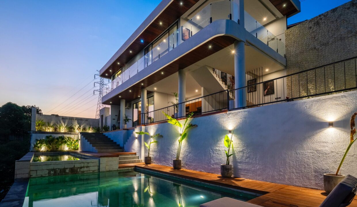 Modern two-story luxury villa with a private pool in Bali at sunset – ideal villa for rent in Bali, Indonesia.