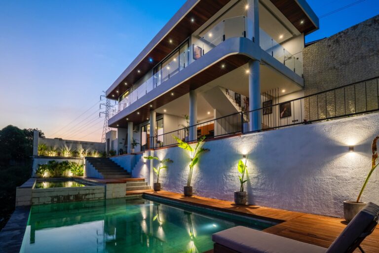 Modern two-story luxury villa with a private pool in Bali at sunset – ideal villa for rent in Bali, Indonesia.