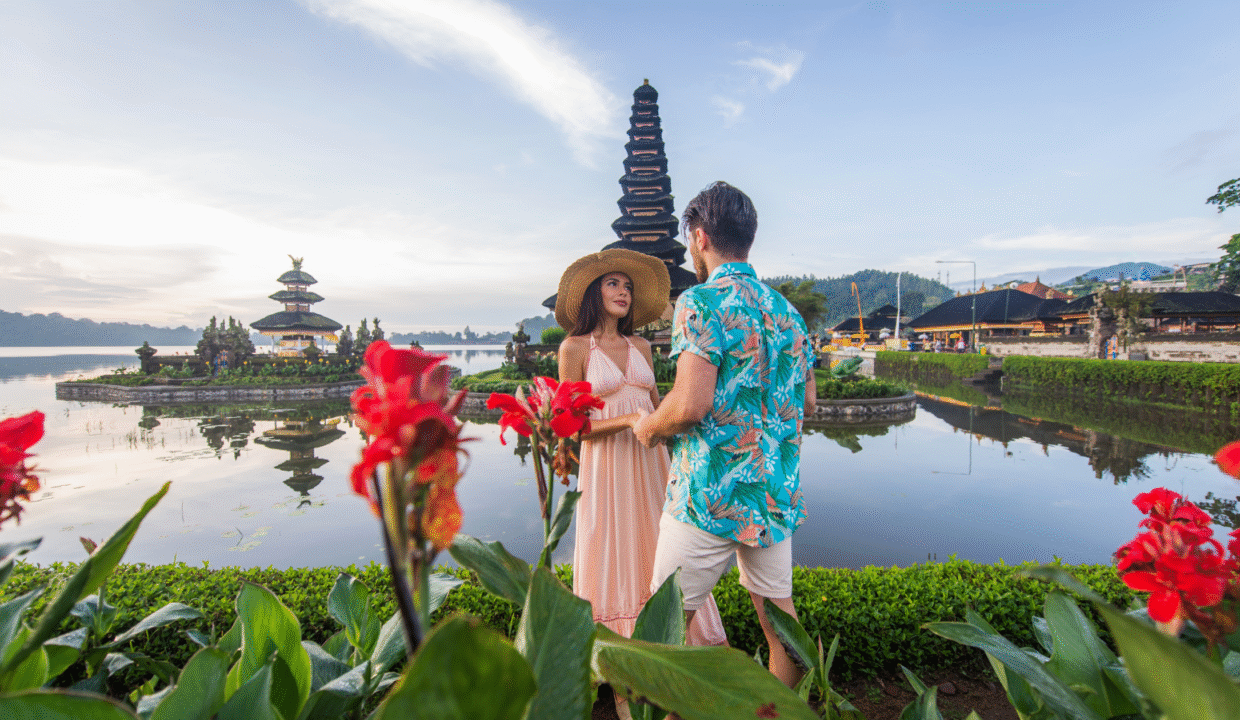 A couple holding hands during their honeymoon in Bali.