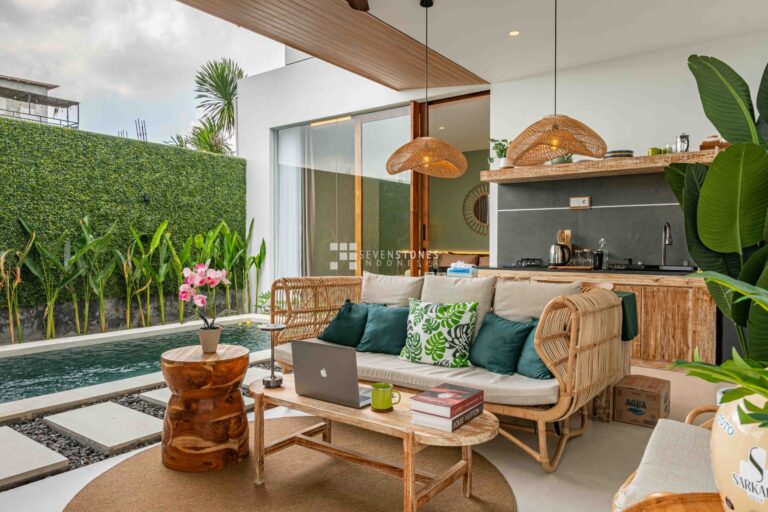Tropical living room with rattan furniture and private pool in an affordable property in Bali, perfect for first-time investors.