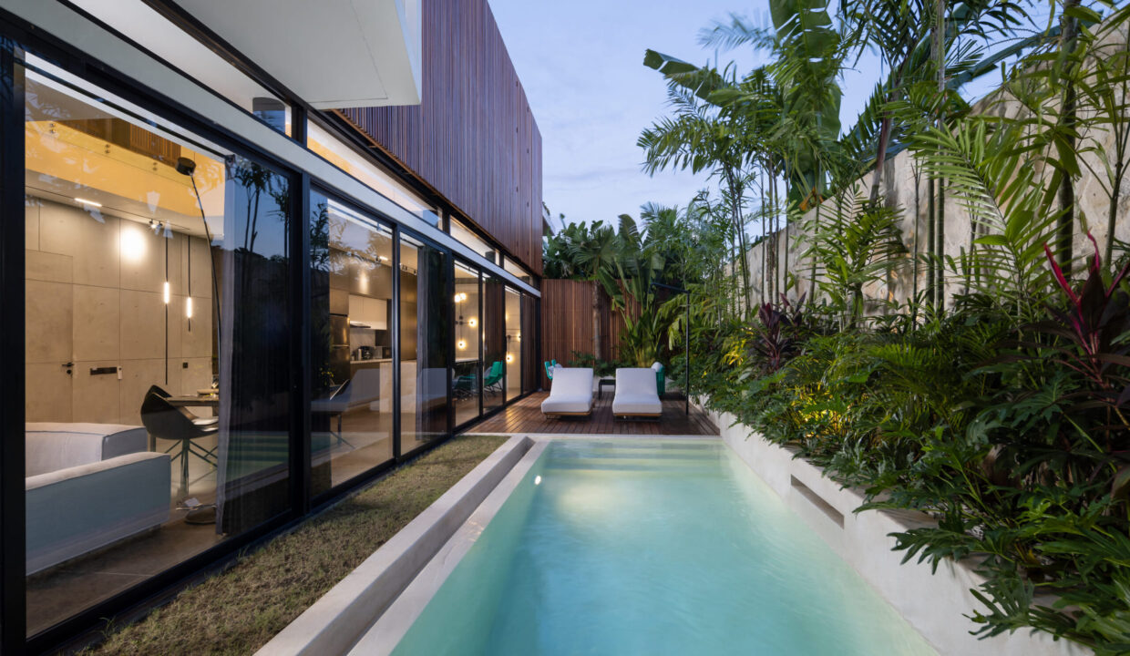 Modern villa in Canggu with private pool, tropical garden, and sleek design, ideal for those looking to buy property in Bali.