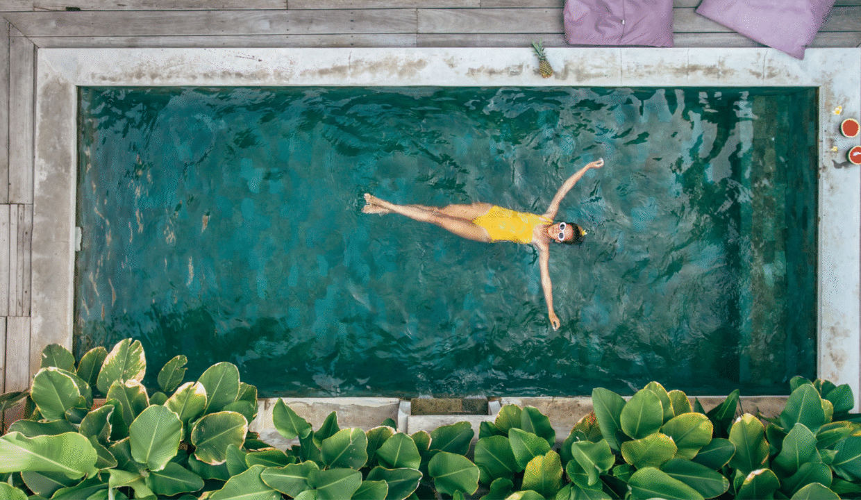 Woman relaxing in a private pool at a villa in Seminyak, showcasing tropical luxury and serene lifestyle.