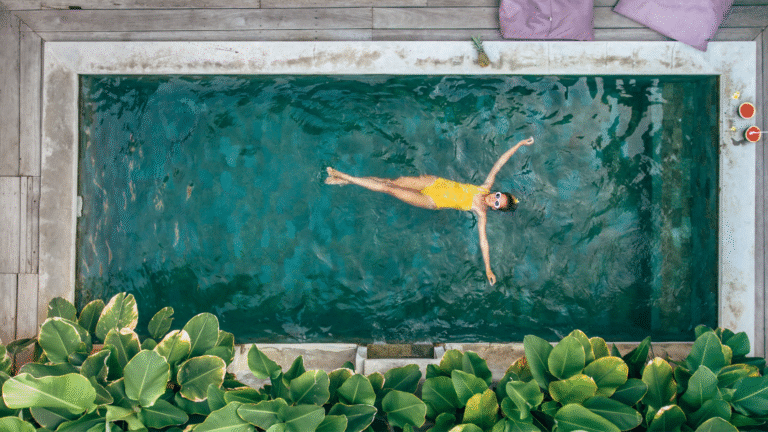 Woman relaxing in a private pool at a villa in Seminyak, showcasing tropical luxury and serene lifestyle.