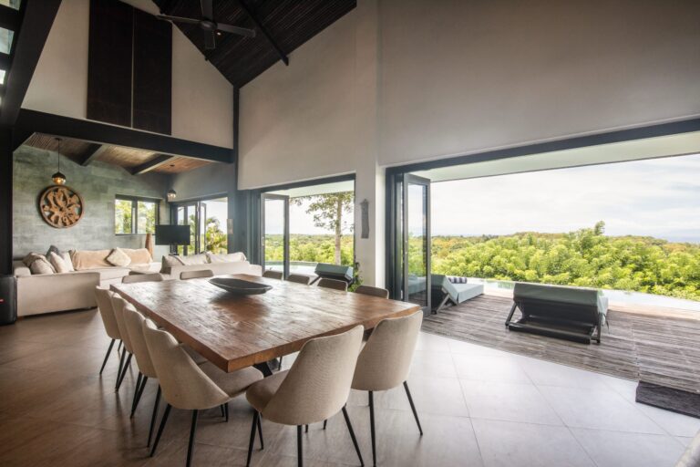 Spacious modern villa interior with open dining and living area overlooking greenery, showcasing the Bali real estate market luxury.