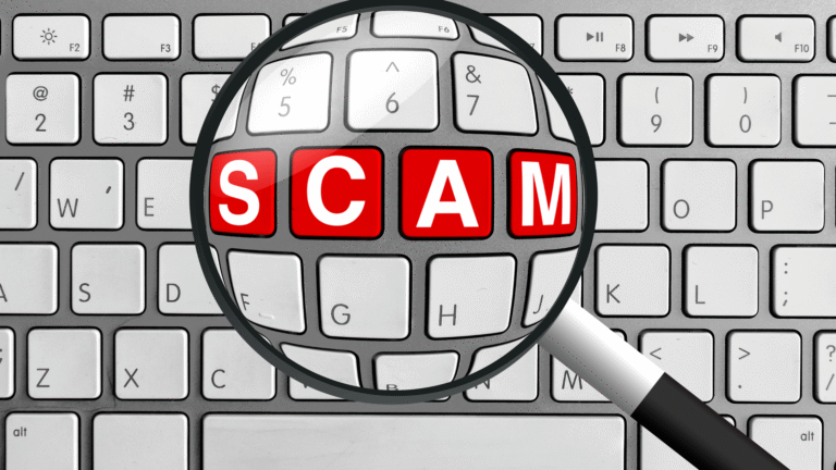 Magnifying glass highlighting the word SCAM on a computer keyboard, symbolizing off-plan property scams in Bali.