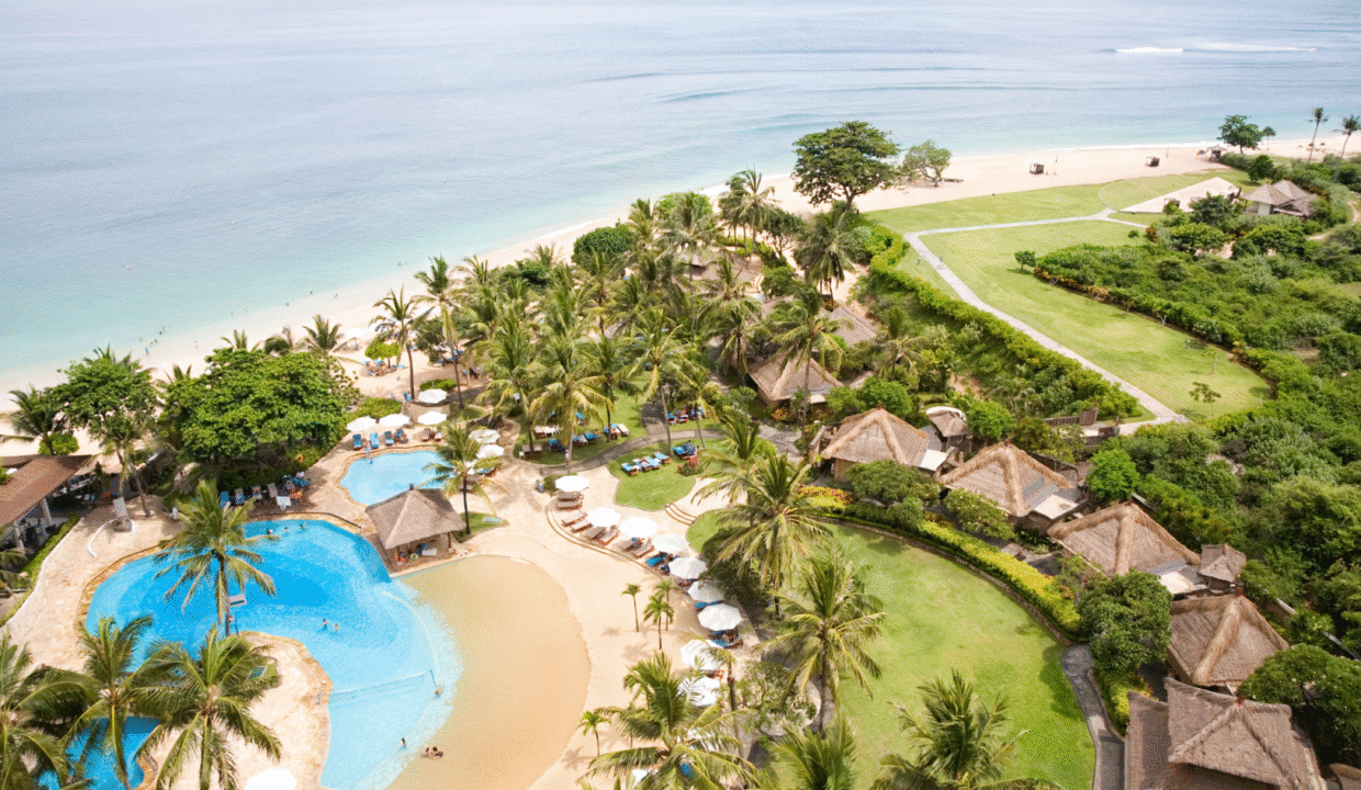 Aerial view of a luxury beachfront resort in Indonesia with pools, villas, and ocean views symbolizing resort investment in Indonesia.