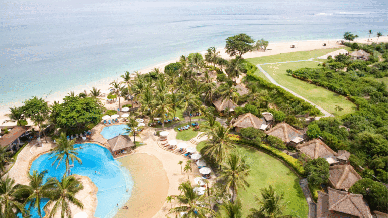 Aerial view of a luxury beachfront resort in Indonesia with pools, villas, and ocean views symbolizing resort investment in Indonesia.