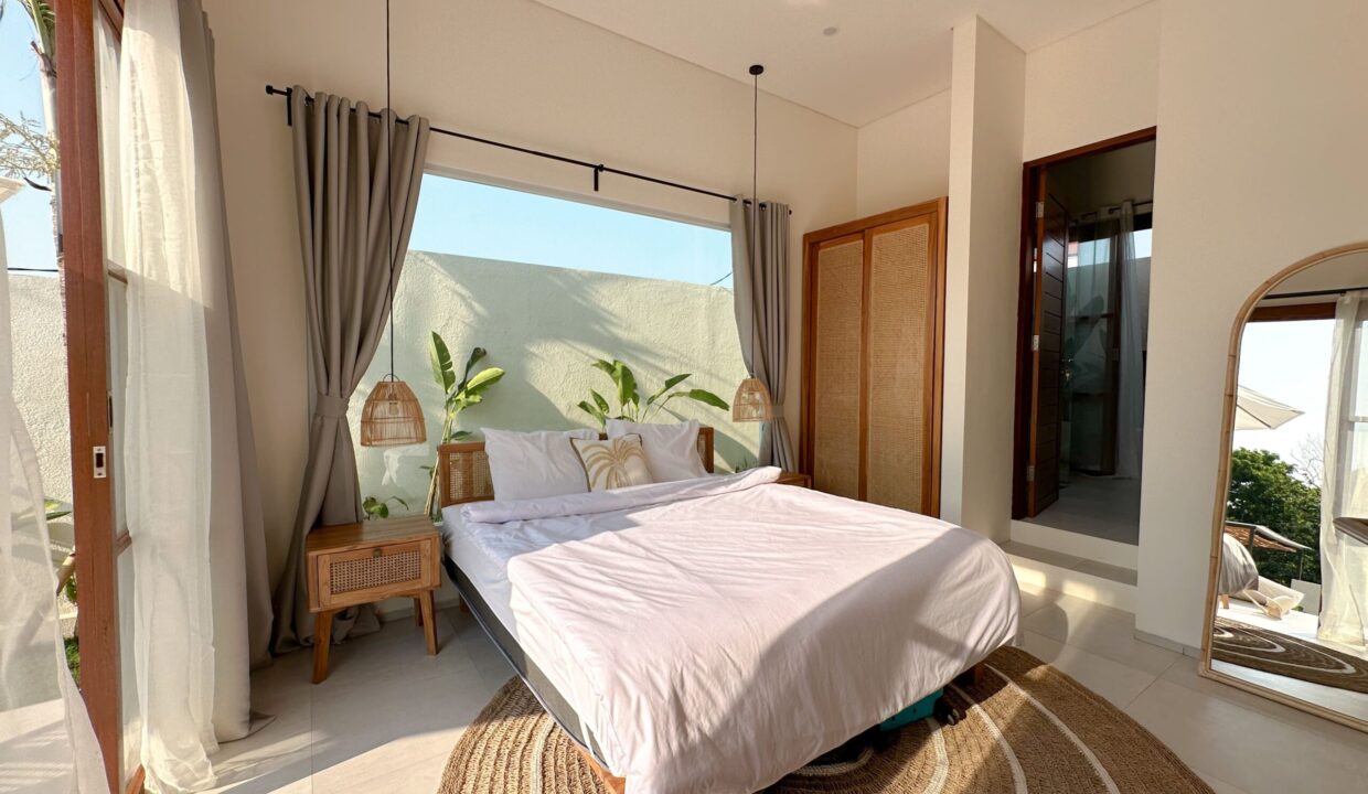 Bright bedroom with modern decor inside a 1 bedroom villa Canggu, featuring natural light and cozy furnishings.