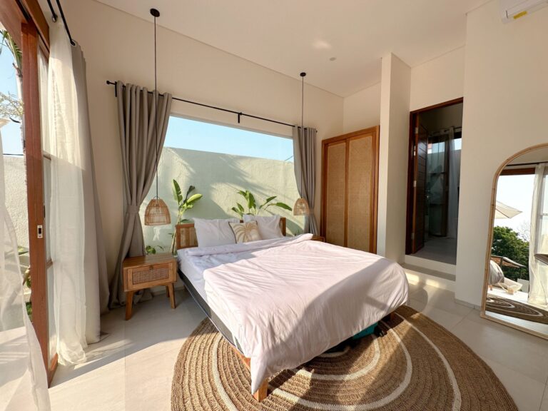 Bright bedroom with modern decor inside a 1 bedroom villa Canggu, featuring natural light and cozy furnishings.