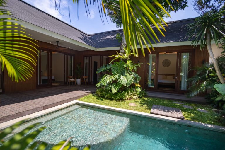 A modern tropical villa with a private pool, wooden deck, and lush garden, showcasing a peaceful retreat ideal for investors searching for an underrated property in Bali.