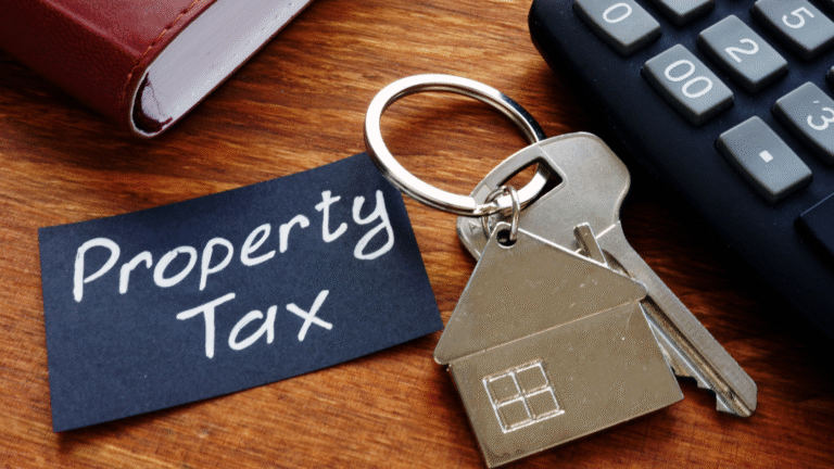 House-shaped keychain and calculator on a desk representing property taxes in Bali.