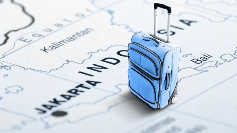 A blue suitcase standing on a map of Indonesia, symbolizing travel and relocation for jobs in Indonesia for foreigners.
