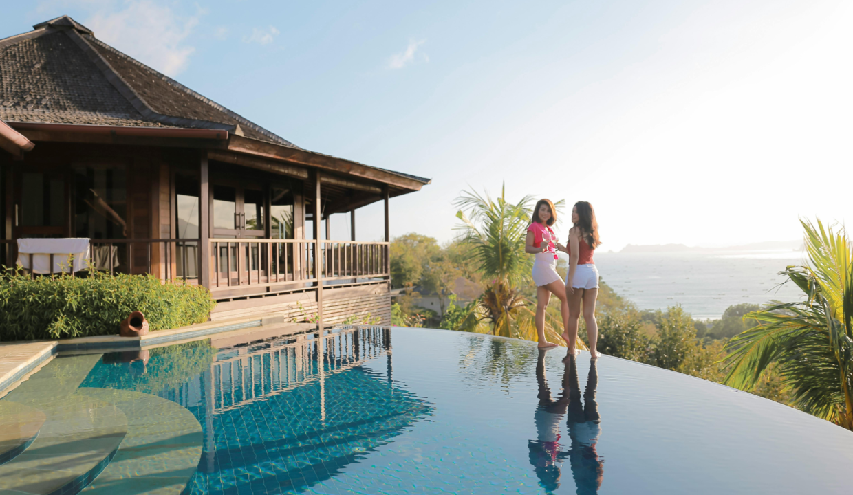 Living in Bali long term in a tropical private villa with an infinity pool overlooking the ocean, showcasing relaxed island living and luxury real estate.
