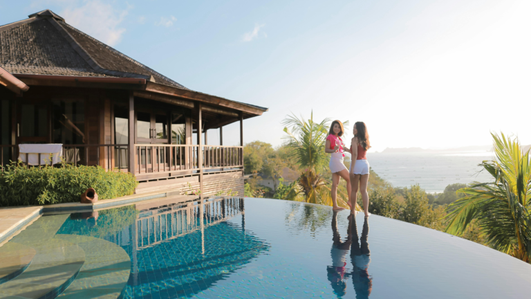 Living in Bali long term in a tropical private villa with an infinity pool overlooking the ocean, showcasing relaxed island living and luxury real estate.