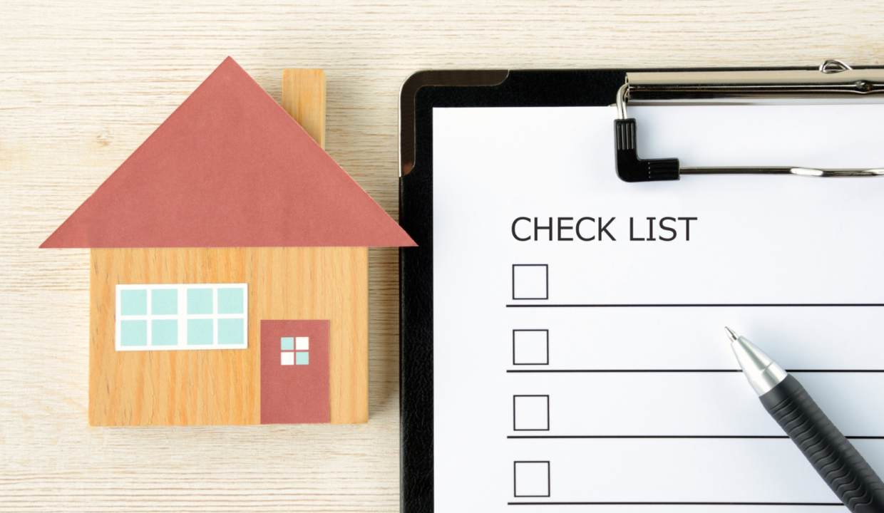 House model beside a clipboard checklist illustrating a checklist for buying a villa in Bali