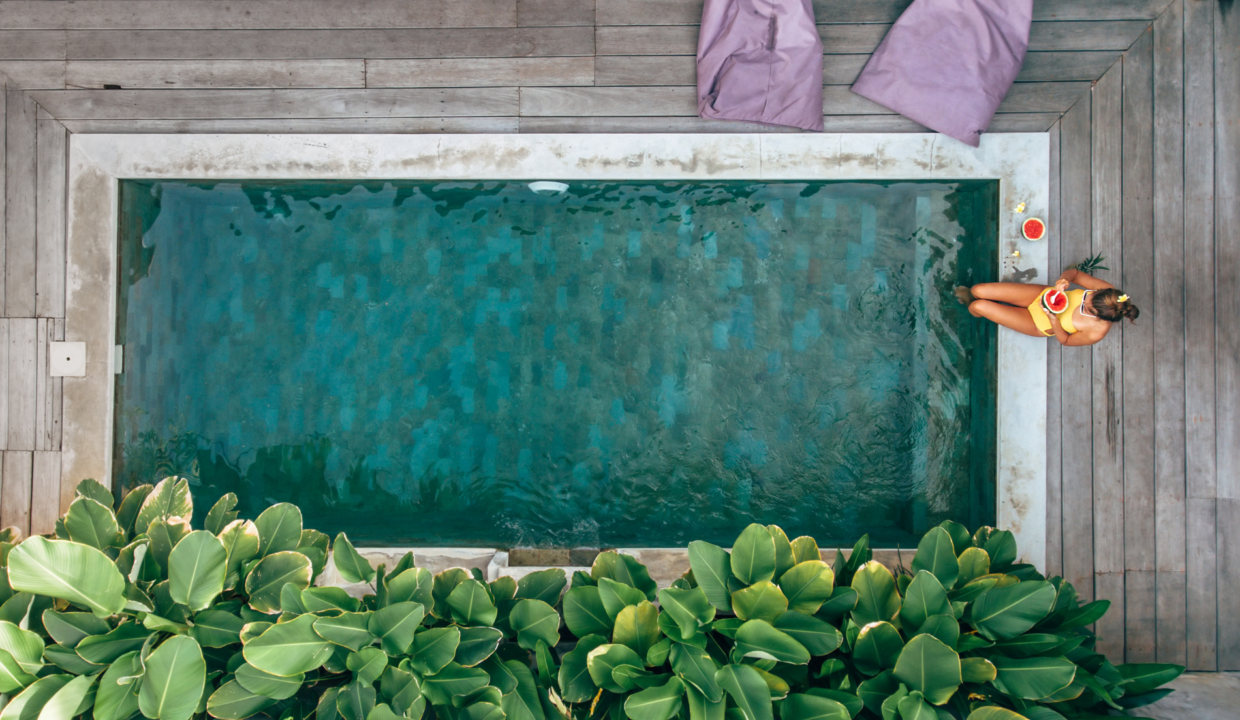 Private villa pool surrounded by tropical greenery, showcasing Bali short-term rentals ideal for a relaxing island getaway.