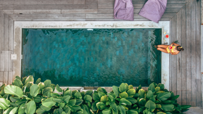 Private villa pool surrounded by tropical greenery, showcasing Bali short-term rentals ideal for a relaxing island getaway.
