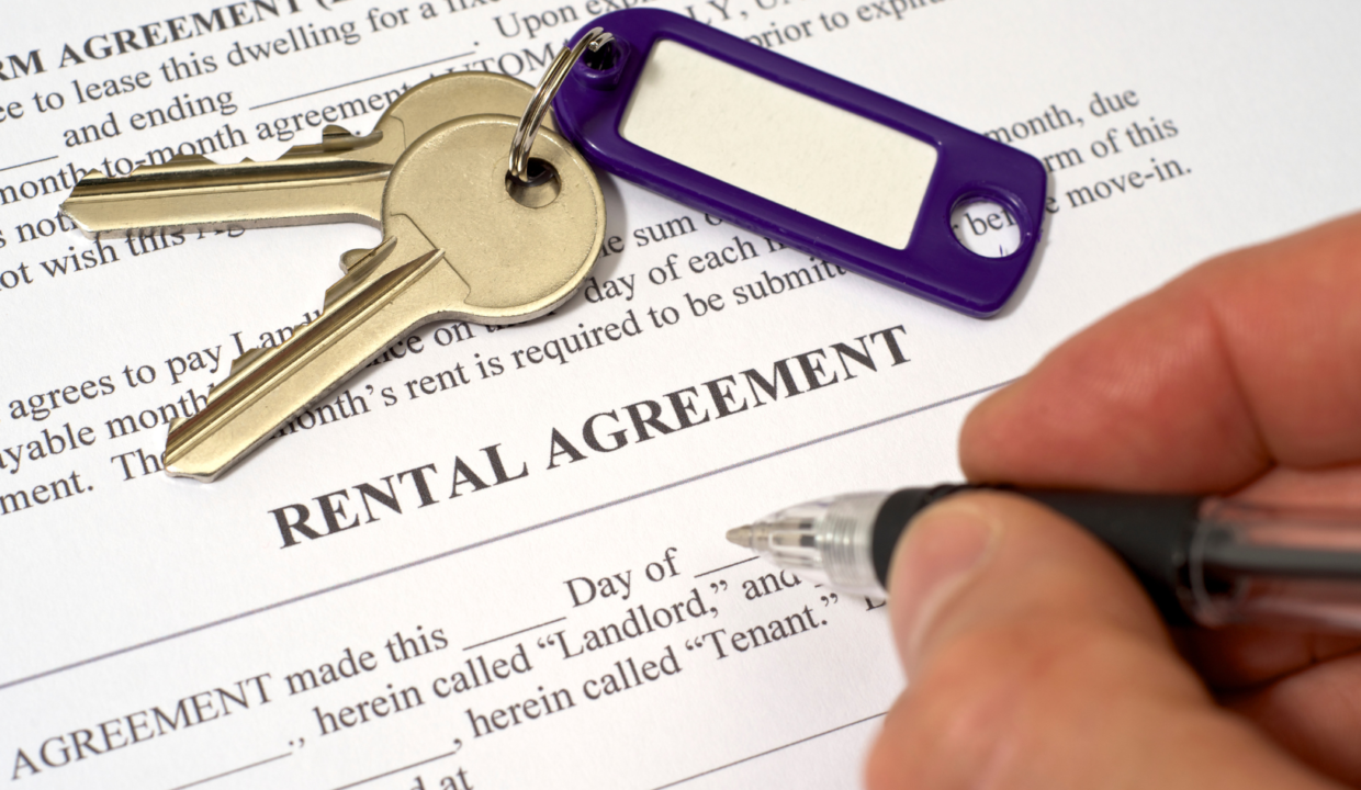 Rental agreements in Indonesia shown with house keys and a pen placed on a signed rental contract, symbolizing property leasing for foreign tenants.