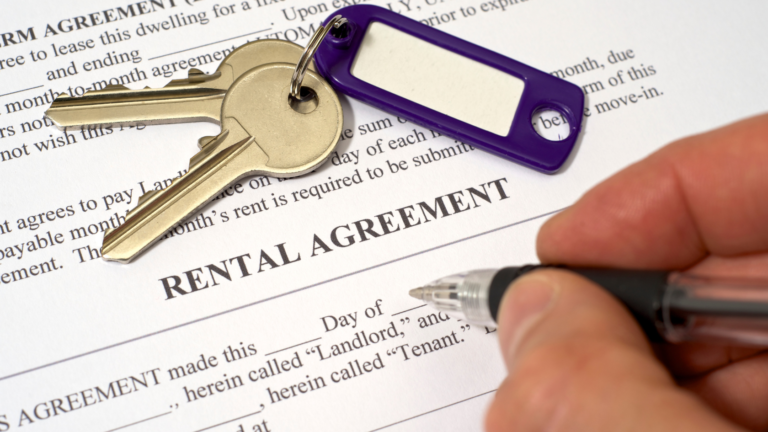 Rental agreements in Indonesia shown with house keys and a pen placed on a signed rental contract, symbolizing property leasing for foreign tenants.